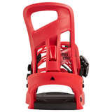 A red snowboard binding shown from the front on a plain white background, with black footplate and black adjustment hardware visible. A small logo and the words 'FREE STILE' are visible on the binding.