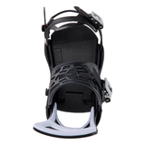 A close-up studio shot of a black snowboard binding from the front, showing the footbed, plastic shell, straps, and white footplate on a solid white background.