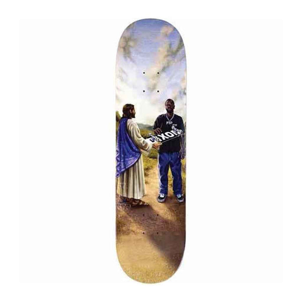 A skateboard deck featuring a printed artwork of Jesus and a man shaking hands on a dirt path under a cloudy sky, shown against a plain white background.