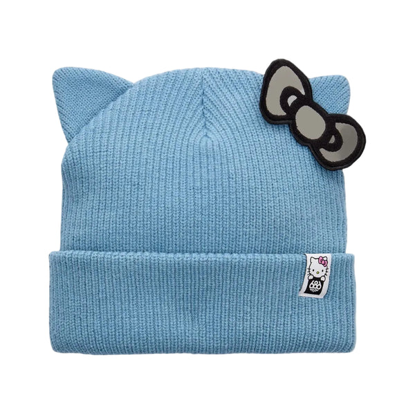 A light blue ribbed knit beanie with cat ears on top and a black-and-gray Hello Kitty bow patch on the side