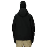 Person wearing a black jacket and beige pants on a white background