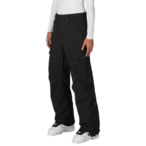 A model wearing black snowboard pants with cargo pockets.