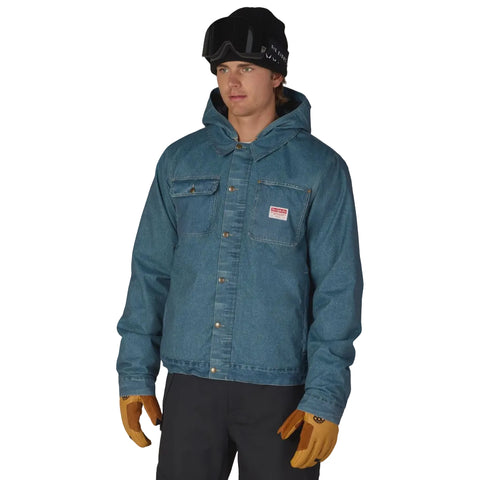 A man wearing a blue hooded denim jacket, standing against a solid white background.
