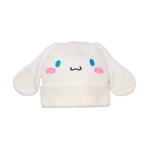 A white plush Cinnamoroll hat with blue eyes, pink cheeks, and a black stitched mouth