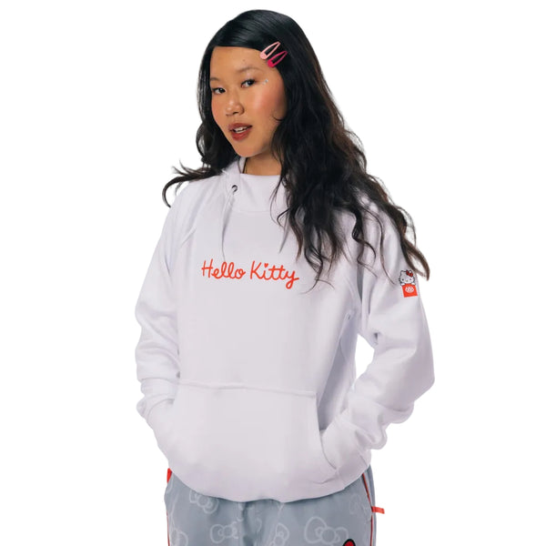 A model wearing a white Hello Kitty zip-up hoodie with red embroidered text on the chest.