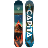 A CAPiTA snowboard shown from both sides against a plain white background. The left side shows a scenic graphic with a moon, desert landscape, mountain, and orange-red geometric shapes, while the right side features a blue and black design with large white CAPiTA lettering.