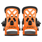 A pair of orange and black snowboard bindings shown from the back on a light gray background, with the brand name 'UNION' printed in black on the orange straps.