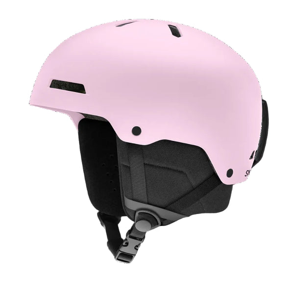 A matte light pink ski helmet with black interior padding and straps, shown from a three-quarters angle on a solid white background.