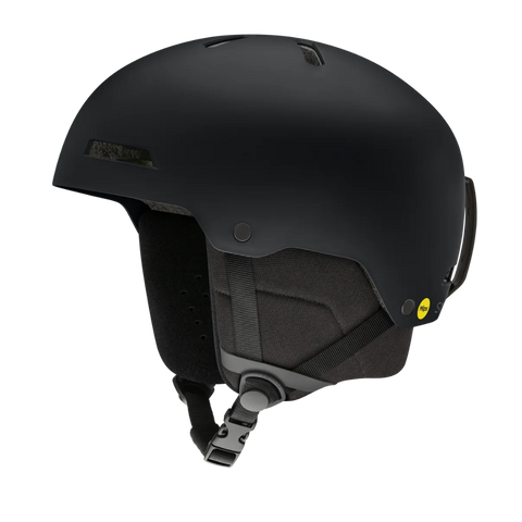 A matte black ski helmet with a dark gray chin strap and a small yellow MTA safety sticker on the side, shown against a solid white background.
