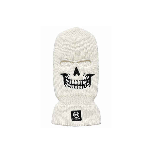 An off-white knit balaclava mask featuring a black embroidered skull face design and a small black square brand patch on the cuff, set against a plain white background.